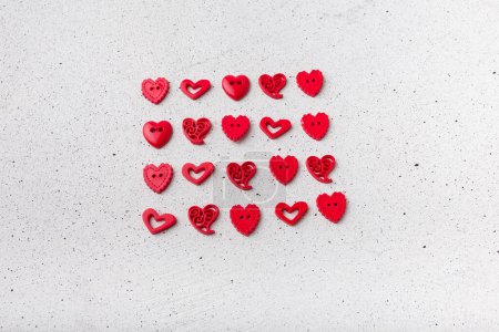 Photo for Set of red decorative heart-shaped buttons on white background. Ornamental details for sewing, scrapbooking, handmade - Royalty Free Image