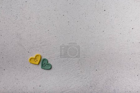 Photo for Two decorative heart-shaped buttons on white background. Ornamental details for sewing, scrapbooking, handmade - Royalty Free Image