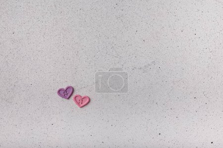 Photo for Two decorative heart-shaped buttons on white background. Ornamental details for sewing, scrapbooking, handmade - Royalty Free Image