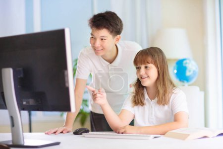 Photo for Kids in school class. Children working on school project. IT, coding and computer lesson. Teenager Asian boy and Caucasian girl study. High or middle school student. - Royalty Free Image
