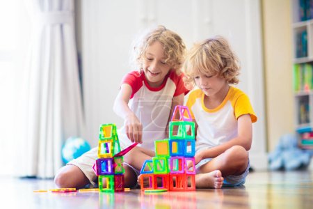 Photo for Child playing with magnetic building blocks. Little boy building tower. Educational toys for kids. Construction toys for young children. Geometry and math game. Preschool fun. - Royalty Free Image