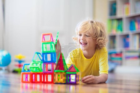 Photo for Child playing with magnetic building blocks. Little boy building tower. Educational toys for kids. Construction toys for young children. Geometry and math game. Preschool fun. - Royalty Free Image