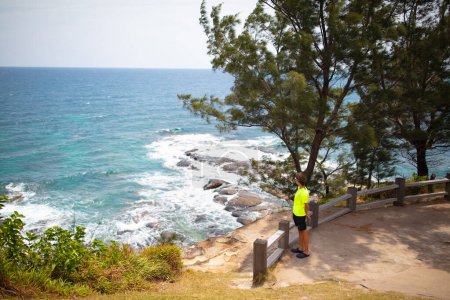 Child hiking on tropical island. Sea and mountain view from top of a hill. Kids hike. Active summer vacation with children. Trekking holiday with young kid. Travel to Asia.