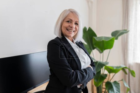 Photo for Close up of happy senior businesswoman crossing her arms - Royalty Free Image
