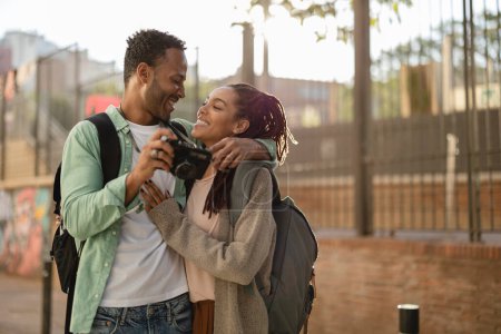 Photo for Happy couple in love celebrating valentine's day - african americans make photos while traveling in the city - Royalty Free Image