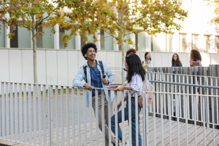 Téléchargez les photos : Étudiants multiraciaux sur le campus universitaire en attente de commencer la classe dans la cour - en image libre de droit