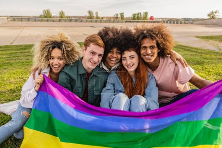 Group of young activist for lgbt rights with rainbow flag, transgenders, homosexual, queers diverse people of gay and lesbian community happy portrait