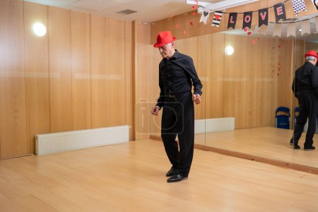 retired man giving dance classes at school