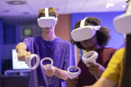Teenagers wearing VR headsets are captivated by an immersive gaming experience in a virtual environment.