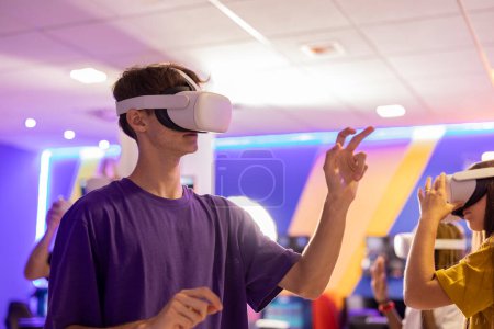 Young adults with VR headsets make hand gestures, fully engaged in an advanced virtual reality gaming experience.