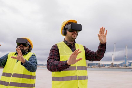 Three construction workers in VR headsets perform a hands-on virtual task, enhancing skills at a dock with industrial cranes.