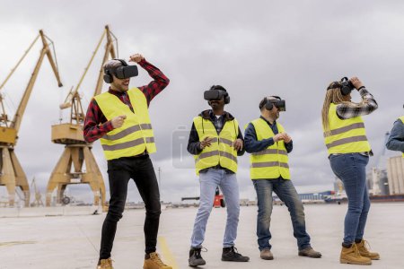 A group of construction workers with VR headsets enthusiastically explores a virtual environment at a dockyard.