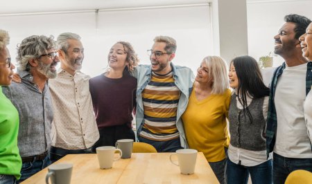 Photo for A diverse team of colleagues is captured in a moment of shared laughter, exemplifying a warm and inclusive office culture. - Royalty Free Image