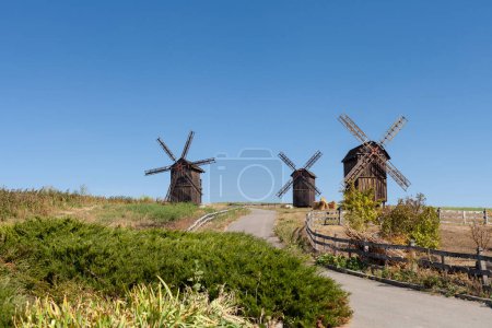 Photo for 3 old windmills in the field - Royalty Free Image