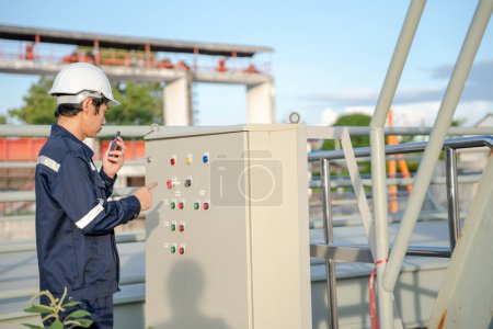 Photo for Mechanic or maintenance or electrical engineer checking main electrical control systems industrial plant. Utility fore man daily check power systems in process. Main Distribution Board, Switchboards - Royalty Free Image