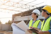 Engineers use blueprint check construction on site. Contractor and inspector inspection construction during project.civil Forman check quality assurance. Audit, inspect, quality control. Longsleeve T-shirt #652850902
