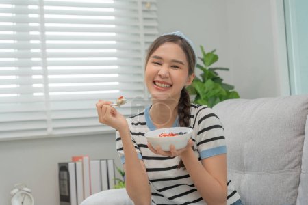 Photo for Healthy food. Beautiful female girl enjoy eat yogurt, granola, fresh fruits on breakfast health in house. Happy young woman smile on morning good emotion. dieting, detox, diet, clean eat, vegetarian - Royalty Free Image
