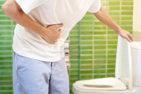 Constipation and diarrhea in bathroom. Hurt man touch belly  stomach ache painful. colon inflammation problem, toxic food, abdominal pain, abdomen, constipated in toilet, stomachache, Hygiene