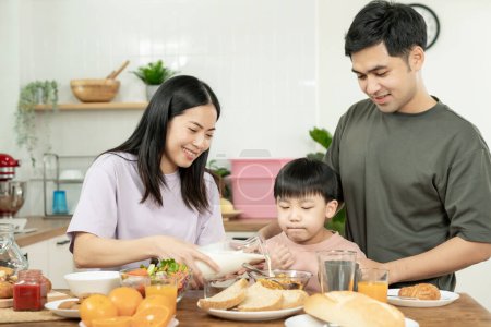 activities together during the holidays. Parents and children are having a meal together during the holidays. Mather prepare milk for son on morning, enjoy, weekend, vacant, family time, happy.