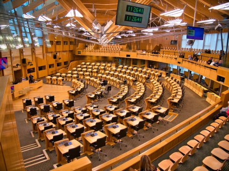 Photo for The debating chamber in the Scottish Parliament Building at Holyrood, Edinburgh, Scotland, UK. 131 desks and chairs seat the elected members and the Scottish Government. - Royalty Free Image