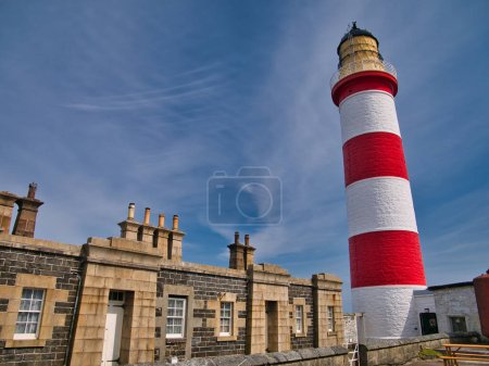 Photo for The lighthouse keeper houses and the red and white Eilean Glas Lighthouse on the east coast of the island of Scalpay in the Outer Hebrides, Scotland, UK. - Royalty Free Image