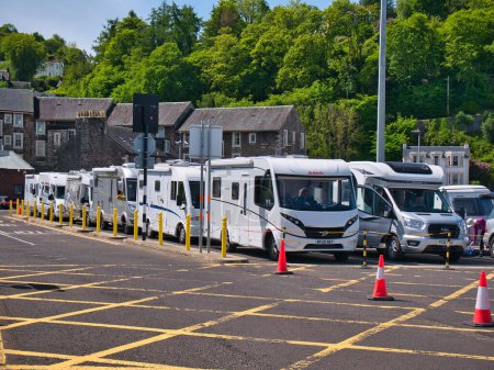 Photo for Motorhomes queue at the CalMac ferry terminal in Oban, Scotland, UK for the ferry to Castlebay on Barra in the Outer Hebrides. - Royalty Free Image