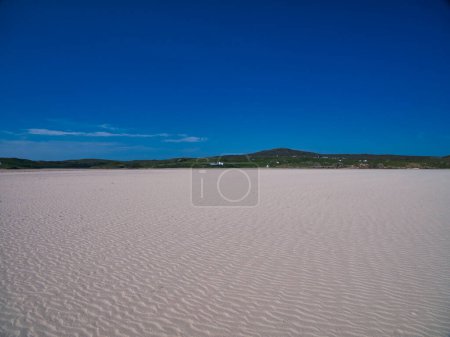 Photo for A view across the deserted Ardroil Sands (Uig Sands) on the Isle of Lewis in the Outer Hebrides, Scotland, UK. Taken with a clear blue sky on a sunny day in summer. - Royalty Free Image