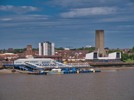 Photo for The floating Mersey Ferries terminal at Seacombe on Wirral, UK. On the right is a ventilation tower for the Kingsway road tunnel under the River Mersey. - Royalty Free Image