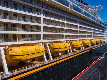 Photo for Tortola, BVI - Jan 23 2024: A row of yellow, enclosed lifeboats on a cruise ship in the Caribbean. - Royalty Free Image