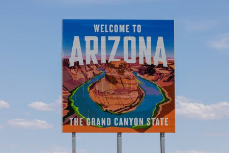 Photo for Welcome to Arizona billboard sign with Horseshoe Bend pictured on the Utah border with blue sky background - Royalty Free Image