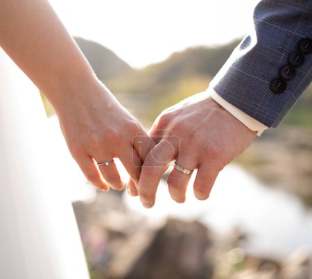 Photo for Bride and Groom walks hand in hand close-up - Royalty Free Image