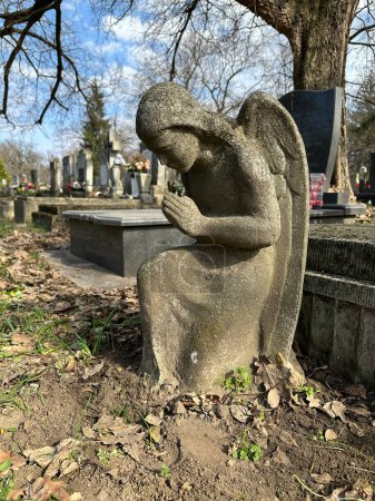Angel figurine in the public cemetery on a tombstone