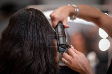 Photo for Professional hairdresser cutting hair of woman in beauty salon, closeup - Royalty Free Image