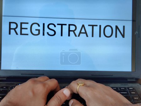 Photo for Picture of a person searching for registration procedure of an entrance exam on a laptop. Registration is written on screen. - Royalty Free Image
