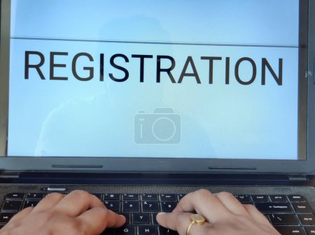 Photo for Picture of a person searching for registration procedure of an entrance exam on a laptop. Registration is written on screen. - Royalty Free Image