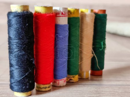 Photo for Picture of set of colorful spool of thread shot against blur background - Royalty Free Image