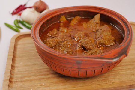 traditional Indian curry lamb masala in a bowl on table.