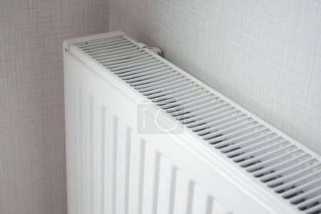 White radiator on grey white wall. apartment heating installation system, .