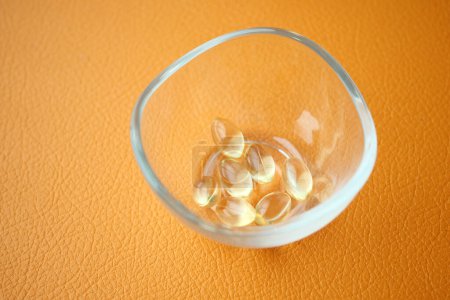 Photo for Omega 3 capsules from fish oil in a container . - Royalty Free Image