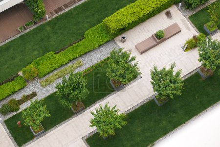 Garden with walkways and green grass. Photo taken from above drone. 