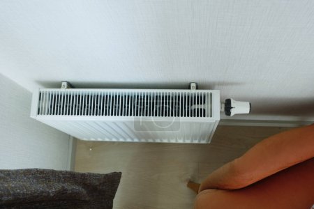 White radiator on grey white wall. apartment heating installation system, .