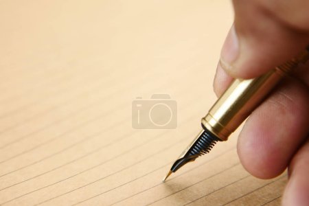 Photo for Mans hand writing with pen on paper. - Royalty Free Image