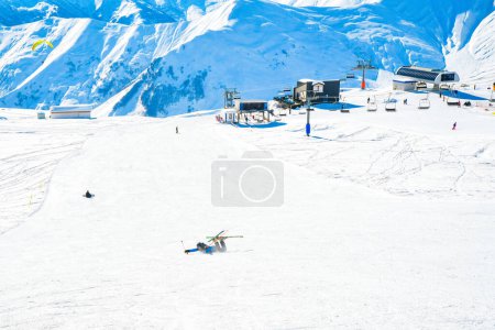 Photo for Close up view snowboarder fall on snow while snowboarding on piste - Royalty Free Image
