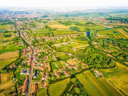 Aerial panoramic view over Westport and Irish green countryside by river in spring