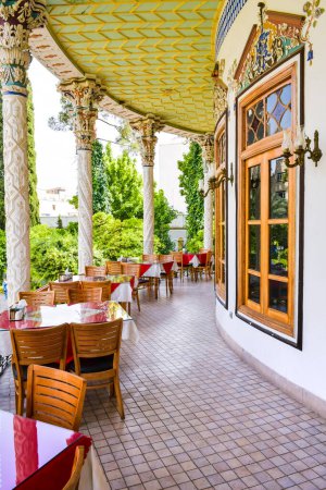 Photo for Shiraz, Iran -10th june, 2022: tables and chairs in popular tourist destination - beautiful house in Shapouri garden in central Shiraz city - Royalty Free Image