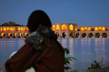 Photo for Isfahan, Iran - 15th june, 2022: tourist visit look at famous travel destination in Iran - Old Khajoo bridge, across the Zayandeh River in Isfahan, Iran. - Royalty Free Image