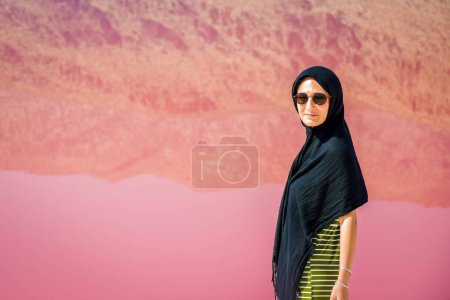 Photo for Caucasian woman tourist stand on Maharlu pink salt lake shore with reflections. Travel destination Iran in Shiraz - Royalty Free Image