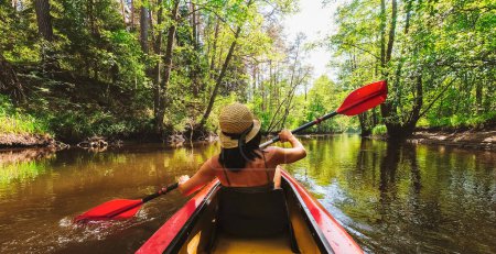 Photo for Back view Kayaking couple in river. POV of woman and man kayaking in beautiful landscape. Aquatic sports during fall autumn concept.Beautiful calm relaxing warm scenic trees autumn - Royalty Free Image