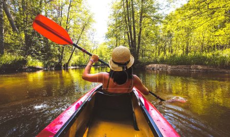 Photo for Back view Kayaking couple in river. POV of woman kayaking in beautiful landscape. Aquatic sports during fall autumn concept.Beautiful calm relaxing warm scenic trees autumn - Royalty Free Image
