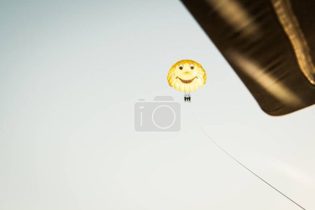 Photo for Parasailing in Batumi. Tourist parasail with yellow smiley face parasail - Royalty Free Image